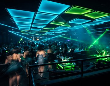 Casino nightclub floor viewed from the DJ booth with lasers and LED lighting